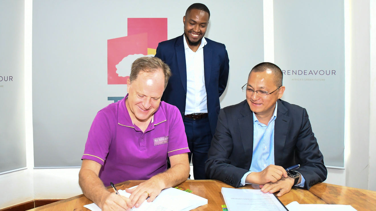 Preston Mendenhall, Wu Jianfei and James Marum(standing) during the signing ceremony of an investment by FullCare at Tatu City. PHOTO/COURTESY